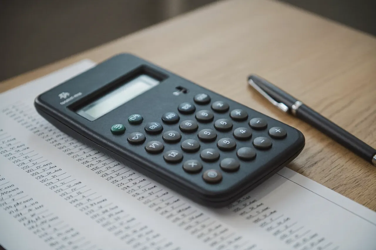A calculator and window quote paperwork spread across a table