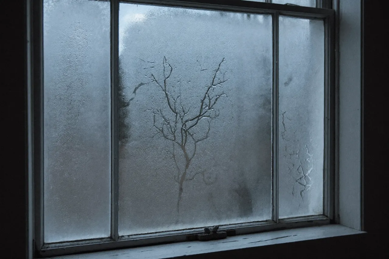 Frost forming on an old single-glazed window in winter