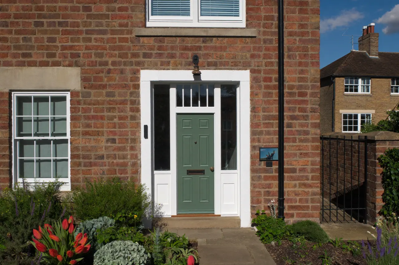 New windows and a front door fitted on a terraced brick house